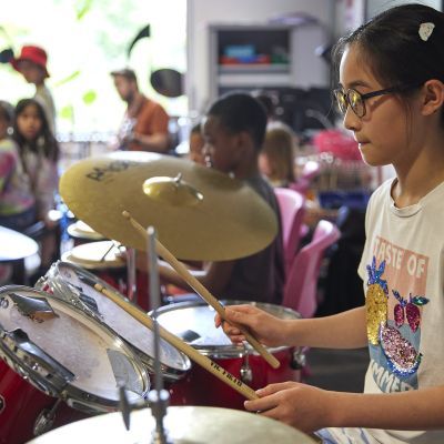 A girl plays the drums